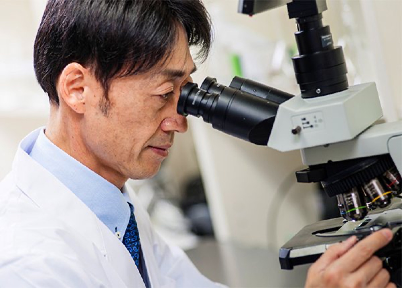 Takaaki Matsumoto looking into a microscope